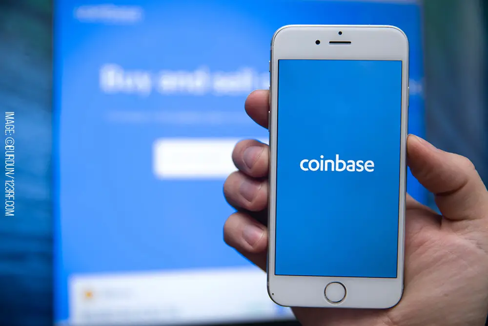 Person holding smartphone with Coinbase on it